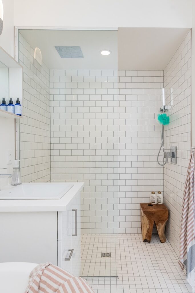 Modern bathroom with elegant fixtures, stylish tiles, and a spacious vanity, reflecting a recent renovation.